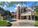 Backyard view featuring a private pool, patio, and lush landscaping at 3855 Greenside Ct, Dacula, GA 30019