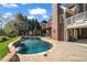 Backyard view featuring a private pool, patio, and lush landscaping at 3855 Greenside Ct, Dacula, GA 30019
