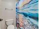 Bathroom featuring a toilet and a bathtub with a vibrant ocean-themed shower curtain at 3855 Greenside Ct, Dacula, GA 30019