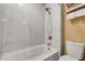 White bathroom with a shower, patterned walls, and a toiletry organizer above the toilet at 3855 Greenside Ct, Dacula, GA 30019