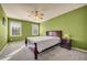 Bedroom featuring green walls, neutral carpet, and two windows with natural light at 3855 Greenside Ct, Dacula, GA 30019