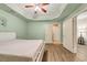 Comfortable bedroom with wood floors and ceiling fan at 3855 Greenside Ct, Dacula, GA 30019