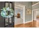 Elegant home entryway featuring a front door with wreath and view into office and front hallway at 3855 Greenside Ct, Dacula, GA 30019