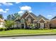 Beautiful two-story brick home with manicured lawn and lush landscaping on a sunny day at 3855 Greenside Ct, Dacula, GA 30019