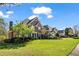 Brick home featuring a well-manicured lawn, mature trees, and a professionally landscaped yard at 3855 Greenside Ct, Dacula, GA 30019