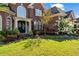 Beautiful front of the house with a well-kept lawn, walkway, and blooming flowers at 3855 Greenside Ct, Dacula, GA 30019