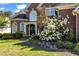 Charming brick home entrance featuring a well-maintained lawn, stone walkway and blossoming shrubs at 3855 Greenside Ct, Dacula, GA 30019