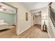Hallway with wood floors, view into bedroom, and staircase at 3855 Greenside Ct, Dacula, GA 30019