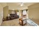 Living room with a ceiling fan and furniture, including a brown sofa and a wooden table at 3855 Greenside Ct, Dacula, GA 30019