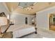Large main bedroom boasts a tray ceiling, neutral tones, and ensuite bathroom access at 3855 Greenside Ct, Dacula, GA 30019