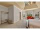 Spacious main bedroom featuring sitting area, tray ceilings, large windows, and neutral carpet at 3855 Greenside Ct, Dacula, GA 30019