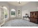 Bright office with arched windows, neutral paint, carpet, and classic furniture at 3855 Greenside Ct, Dacula, GA 30019