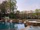 Beautiful pool and stone hot tub with waterfall features and lush greenery at 3855 Greenside Ct, Dacula, GA 30019