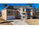 Charming home with a large front yard and driveway leading up to the attached garage at 4197 Trotters Way Dr, Snellville, GA 30039