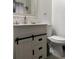 Bathroom vanity with toilet and barn-door style cabinet at 1074 Hobson Sw St, Atlanta, GA 30310