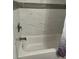 Clean white bathtub with tiled surround at 1074 Hobson Sw St, Atlanta, GA 30310