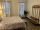 Bright bedroom featuring a ceiling fan and comfortable queen bed with patterned bedding at 1074 Hobson Sw St, Atlanta, GA 30310