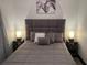 Bedroom showcases a comfortable bed with a tufted headboard and matching lamps on the nightstands at 1074 Hobson Sw St, Atlanta, GA 30310