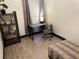 Inviting bedroom features stylish shelving unit, modern desk and comfy chair with a leopard print ottoman at 1074 Hobson Sw St, Atlanta, GA 30310