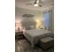 Bright bedroom featuring a ceiling fan and comfortable queen bed with patterned bedding at 1074 Hobson Sw St, Atlanta, GA 30310