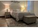 Cozy bedroom featuring a comfortable queen bed with patterned bedding and matching storage ottoman at 1074 Hobson Sw St, Atlanta, GA 30310