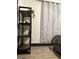 Bedroom featuring a dark wood shelving unit with stylish decorations, next to a neatly made bed at 1074 Hobson Sw St, Atlanta, GA 30310