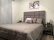 Relaxing bedroom showcasing a well-made bed with a tufted headboard, soft pillows, and coordinating nightstands at 1074 Hobson Sw St, Atlanta, GA 30310