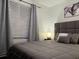 Bedroom featuring a bed with a tufted headboard and matching lamps on the nightstands, underneath wall art at 1074 Hobson Sw St, Atlanta, GA 30310