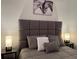 Inviting bedroom featuring a comfortable bed with a tufted headboard and matching lamps on the nightstands at 1074 Hobson Sw St, Atlanta, GA 30310