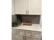 Clean kitchen counter features white cabinets and gray subway tile backsplash at 1074 Hobson Sw St, Atlanta, GA 30310
