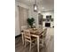 Charming dining area with view to kitchen, featuring wood table and decorative lighting at 1074 Hobson Sw St, Atlanta, GA 30310