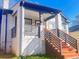 Charming home featuring a covered porch with painted steps and a landscaped front yard at 1074 Hobson Sw St, Atlanta, GA 30310