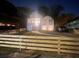 Nighttime view of a charming home featuring a new wooden fence, enhancing curb appeal and providing privacy at 1074 Hobson Sw St, Atlanta, GA 30310