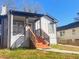Charming home with a modern exterior featuring a brick chimney, cozy front porch, and freshly painted brick and siding at 1074 Hobson Sw St, Atlanta, GA 30310