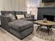 Comfortable sectional sofa with a modern fireplace and stylish round coffee table in the living room at 1074 Hobson Sw St, Atlanta, GA 30310