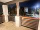 Spacious porch featuring stone columns, a wood railing, and a view of the peaceful neighborhood at night at 1074 Hobson Sw St, Atlanta, GA 30310