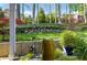 Picturesque backyard featuring a stone retaining wall, decorative fountain, and well-manicured landscaping at 5452 Tally Green Dr, Marietta, GA 30068