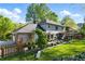Well-manicured backyard features a covered patio, lush green lawn, and lovely landscaping at 5452 Tally Green Dr, Marietta, GA 30068
