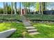 Landscaped backyard featuring stone steps and a retaining wall with lush greenery at 5452 Tally Green Dr, Marietta, GA 30068
