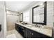 Elegant bathroom with dual sinks, granite countertops, decorative mirrors and tiled walls provides a spa-like feel at 5452 Tally Green Dr, Marietta, GA 30068