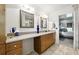 Bright bathroom with double sinks, framed mirrors and an open view of the bedroom at 5452 Tally Green Dr, Marietta, GA 30068