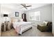 Cozy bedroom with a ceiling fan, bedside table, and plush chair near the window offering natural light at 5452 Tally Green Dr, Marietta, GA 30068