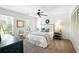 Bright bedroom with white walls, two windows, ceiling fan, and neutral carpet offers comfort and style at 5452 Tally Green Dr, Marietta, GA 30068
