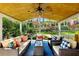 Charming covered patio with comfortable seating, ideal for enjoying the serene outdoor ambiance and landscaped yard at 5452 Tally Green Dr, Marietta, GA 30068