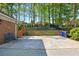 Long driveway area, with an adjacent brick wall, blue bench and picket fence at 5452 Tally Green Dr, Marietta, GA 30068