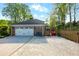 Wide driveway leads to a spacious two-car garage and a red-gated side entrance at 5452 Tally Green Dr, Marietta, GA 30068