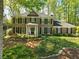 Charming brick home featuring a manicured front yard and mature trees at 5452 Tally Green Dr, Marietta, GA 30068