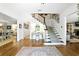 Elegant foyer with hardwood floors and a staircase adorned with decorative pictures at 5452 Tally Green Dr, Marietta, GA 30068