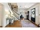 Inviting foyer featuring hardwood floors, a staircase, and a black front door at 5452 Tally Green Dr, Marietta, GA 30068