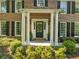 Classic brick home featuring a welcoming front porch with stately columns at 5452 Tally Green Dr, Marietta, GA 30068